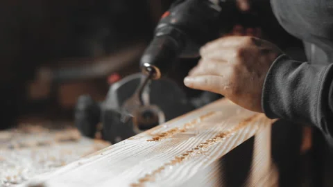 A man works with a drill in his workshop Stock Footage 194681453