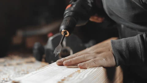 A man works with a drill in his workshop Stock Footage 194681508