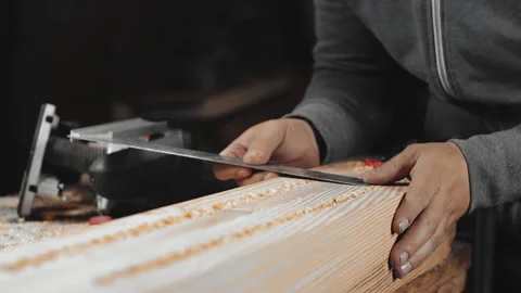 A man works with a drill in his workshop Stock Footage 194681581