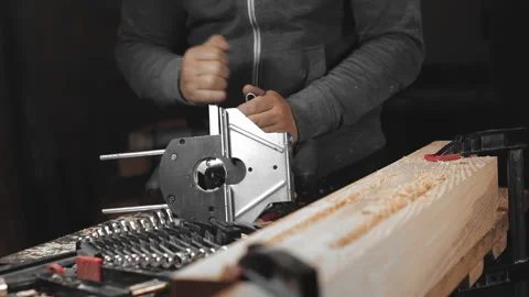 A man works with a drill in his workshop Stock Footage 194681619