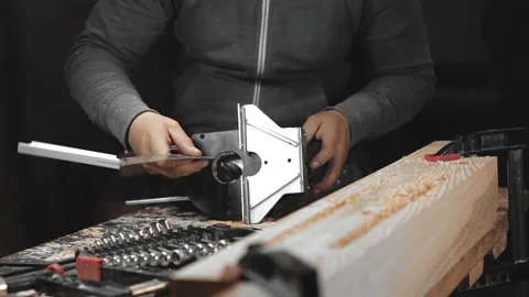 A man works with a drill in his workshop Stock Footage 194681739