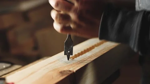 A man works with a drill in his workshop Stock Footage 194681789