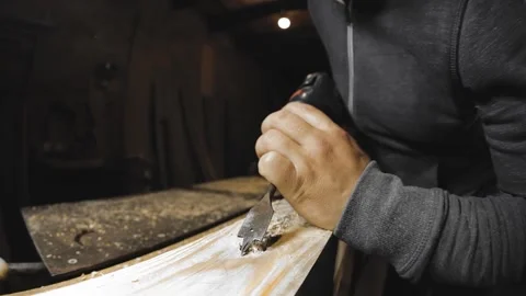 A man works with a drill in his workshop Stock Footage 194681827