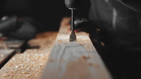 A man works with a drill in his workshop Stock Footage 194681852