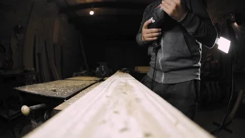 A man works with a drill in his workshop Stock Footage 194681886