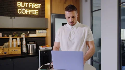 A man works during a coffee break in the office with a laptop Stock Footage 201921442
