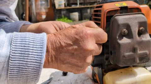A man works with a gasoline engine. Stock Footage 306363701