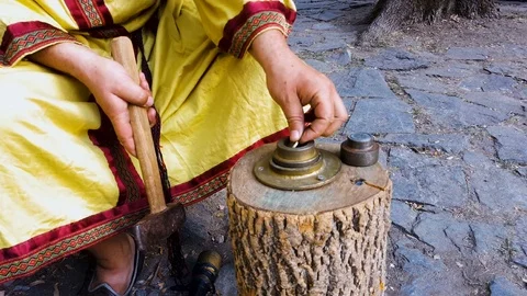 Man works hammer minting ancient coin during historical reconstruction amateur Stock Footage 81620667