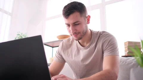 Man works from home sitting on sofa Video stock 171542052