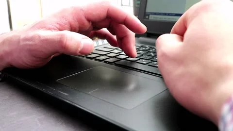 A man works in the house for a computer, his hands are typing Stock Footage 147927293