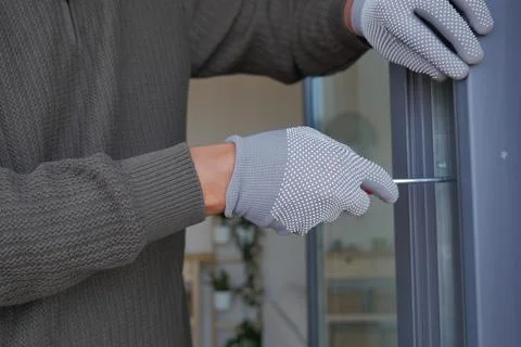 Man works on installing a window in a home Stock Photos