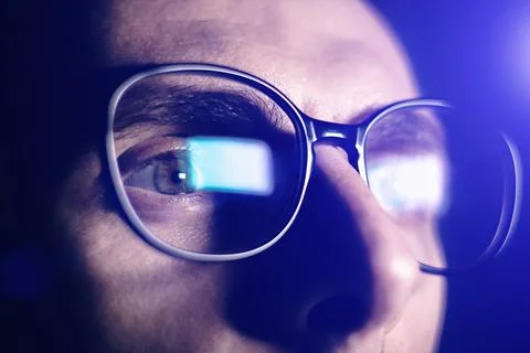 Man works on internet. Reflection at the glasses from laptop..Close up of m.. Stock Photos