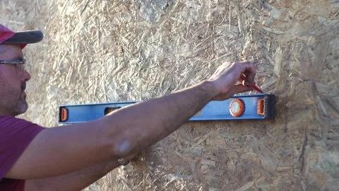 A man works with a level 4K Stock Footage 294047195