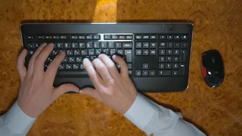 The man works for a long time at the computer keyboard Video stock 152009679