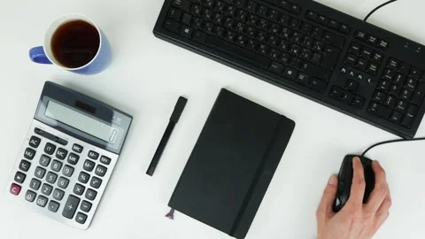 A man works with a mouse in front of a computer and enters information Stock Footage 101839337