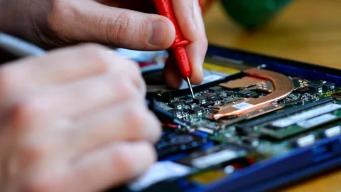 A man works with a multimiter, measures voltage. Repair of equipment. Stock Footage 147741723