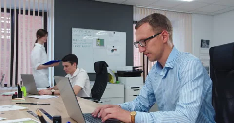 A man works in an office at a computer Видео 159551743