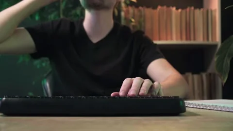 A man works in the office at a computer, a guy works at a computer at home Stock Footage 264130587