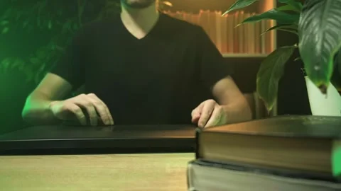 A man works in the office at a computer, a guy works at a computer at home Stock Footage 264131258