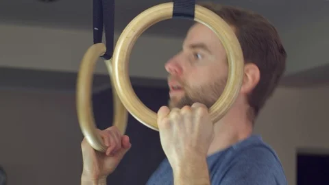 Man Works Out Pull-ups on Gymnastics Rings at Home Video stock 128207837