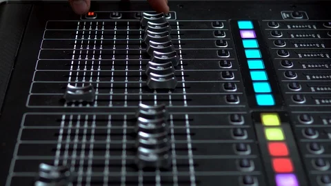 Man works on a professional electronic audio mixer. A control panel for tuning 库存影片 114085261