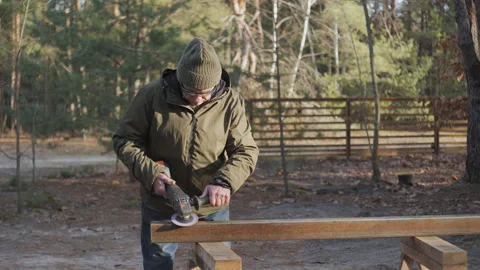 A man works on a project to process steel products in a wooded area during Stock Footage 297983849