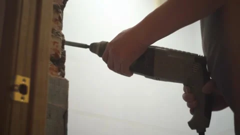 A man works with a puncher in an apartment. Chips off, breaks tiles Stock Footage 147597331