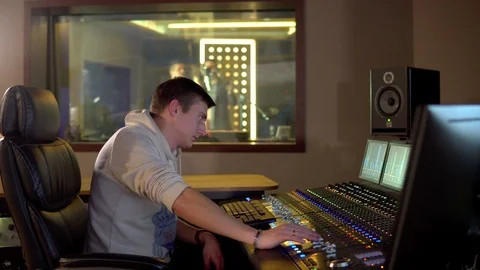 A man works in a recording studio Stock Footage 104076163