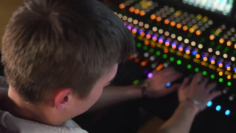 A man works in a recording studio on a mixing console. Stock Footage 104630732