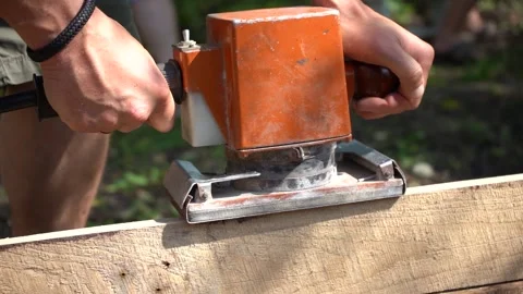Man works with sander machine, carpenter with grinding machine polish wooden  Stock Footage 155011611