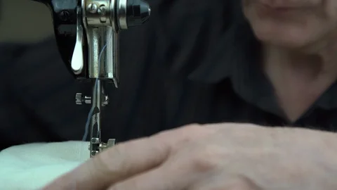 Man works on sewing machine and needle moves up and down Stock Footage 127150557