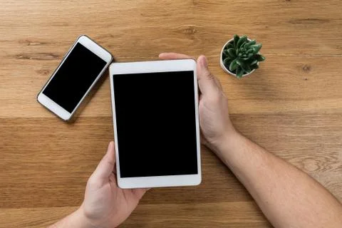 Man works using digital devices. Above view of desktop workspace. Stock Photos
