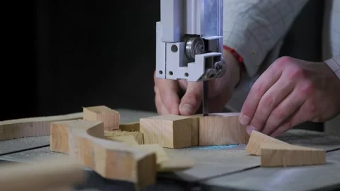 A man works with wood in a workshop. Working with wooden blanks. Stockbeeldmateriaal 294174264