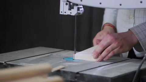 A man works with wood in a workshop. Working with wooden blanks. A man drills Video stock 294375439