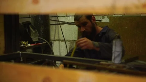Man in the workshop is busy measuring Stock Footage 80932254