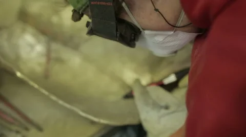 Man in a workshop using a tool powered by compressed air to polish a statue Stock Footage 58641713