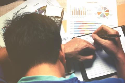 Man worrying and counting using calculator and stress in problem about cost. Stock Photos