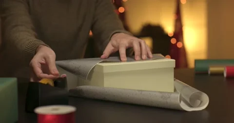 Man wrapping a christmas present Stock Footage 143849135