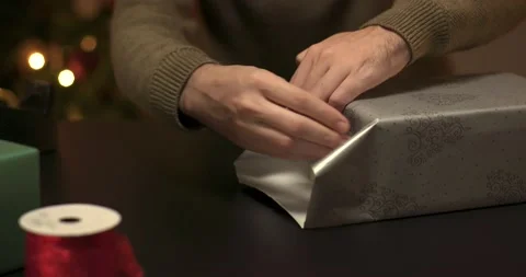Man wrapping a christmas present Stock Footage 143849210