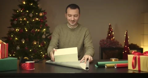 Man wrapping a christmas present Stock Footage 143849412