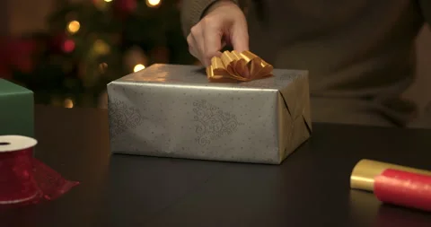Man wrapping a christmas present Stock Footage 143849880