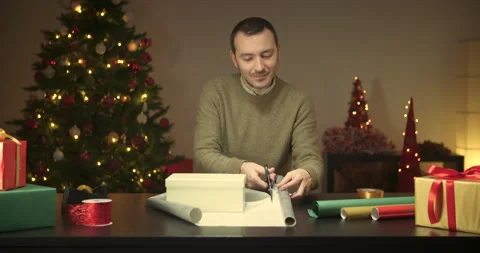 Man wrapping a christmas present Stock Footage 143850270