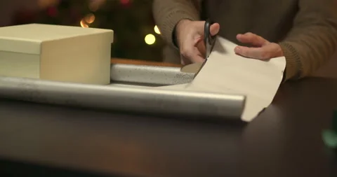 Man wrapping a christmas present Stock Footage 143850374