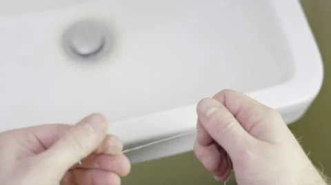 Man wrapping floss around his finger Видео 51915006