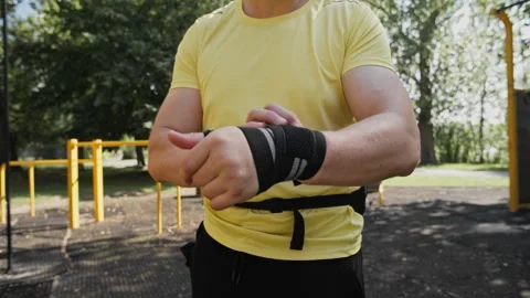 Man Wrapping Wrist Wraps Around His Wrist Stock Footage 341612344
