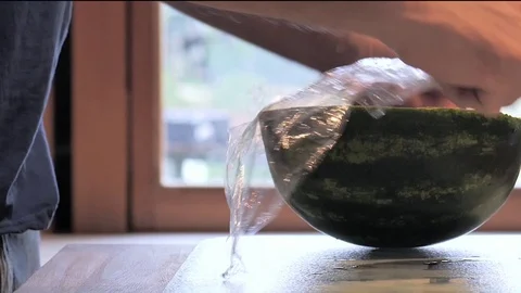 A man wraps   watermelon Stock Footage 116914151