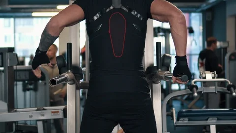 Man wringing out on bars in gym, rear view Stock Footage 100985335