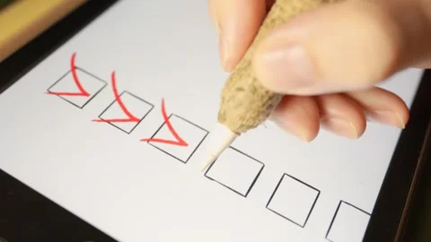 A man write a checkmark in check box on tablet with red color. To do list or Stock Footage 340905142