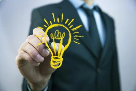 Man write light bulb on screen Stock Photos