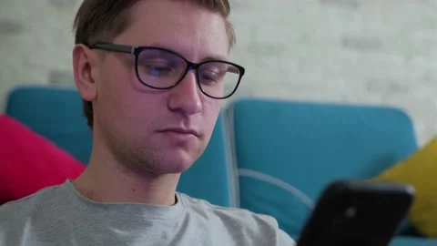 Man write a message using a mobile phone, staying isolated at home. Stock Footage 144490165